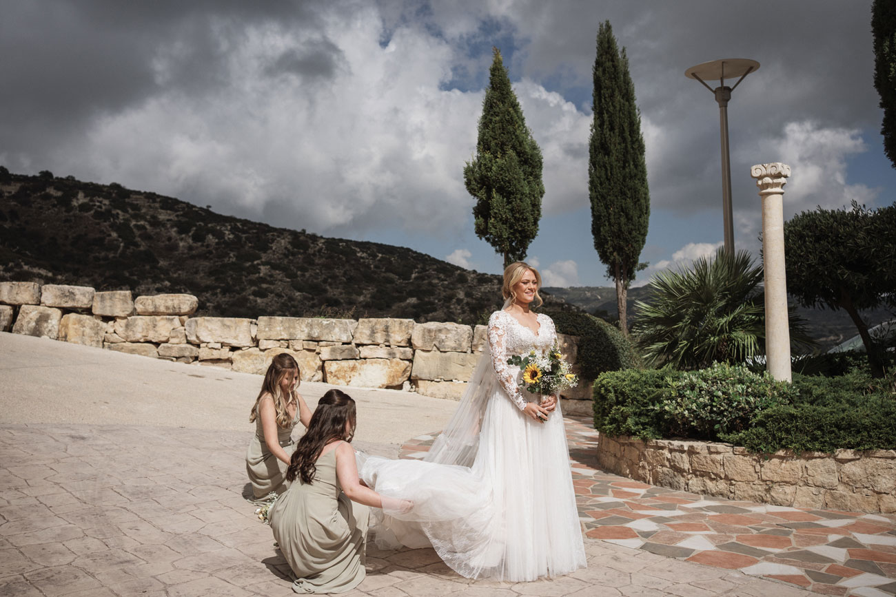 wedding Bridesmaids holding the bride’s wedding gown before the ceremony at Panorama Wedding Cyprus Villas.